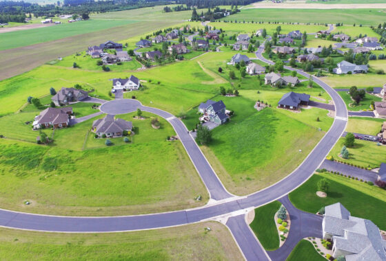 aerial view of a green residential neighborhood with winding roads